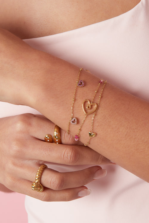 Armband met roze steentjes in hartjes