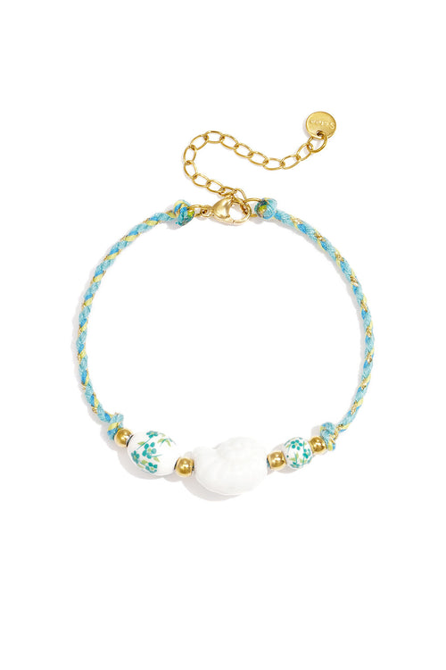 Armband van touw met schelp en kralen met bloemdesign