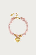 Hartjes armband roze van gevlochten polyester met gouden chunky hart bedel en stainless steel sluiting