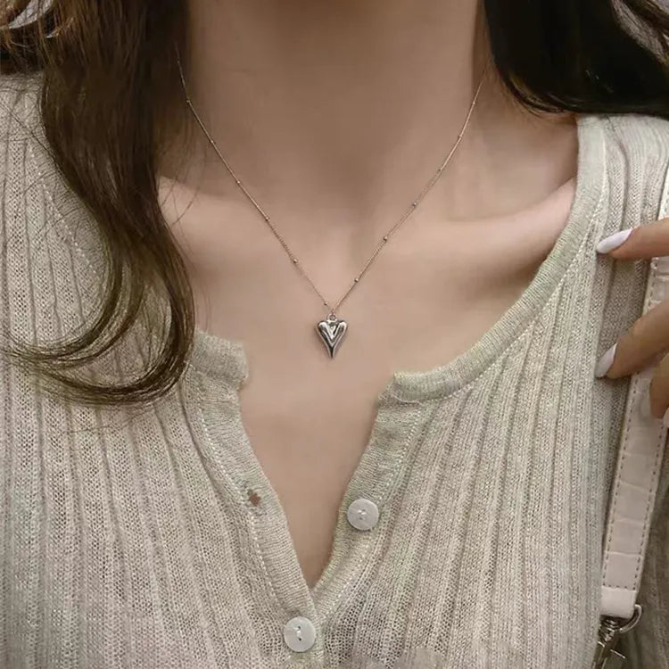 Stijlvolle zilverkleurige hartjes ketting van stainless steel gedragen door een vrouw. Perfecte accessoire voor dames.