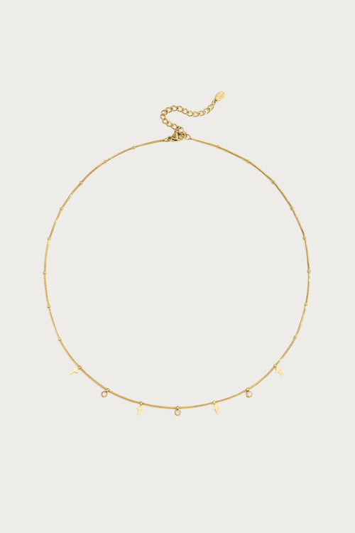 Goudkleurige stainless steel ketting met fijne schakels en hangerdetails, waaronder sleutels en strass steentjes