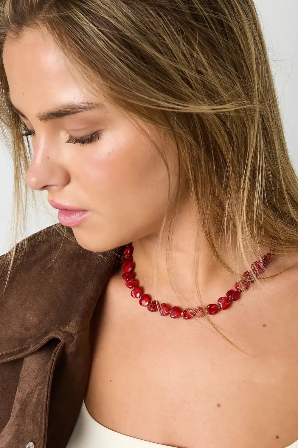 Model draagt Crimson Beads – Kralen Ketting – Stainless Steel met glanzende rode kralen, ideaal voor een gelaagde sieradenstijl.