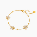Gouden Flora armband van roestvrij staal met glimmende bloemhangers en bolletjes, dames sieraad