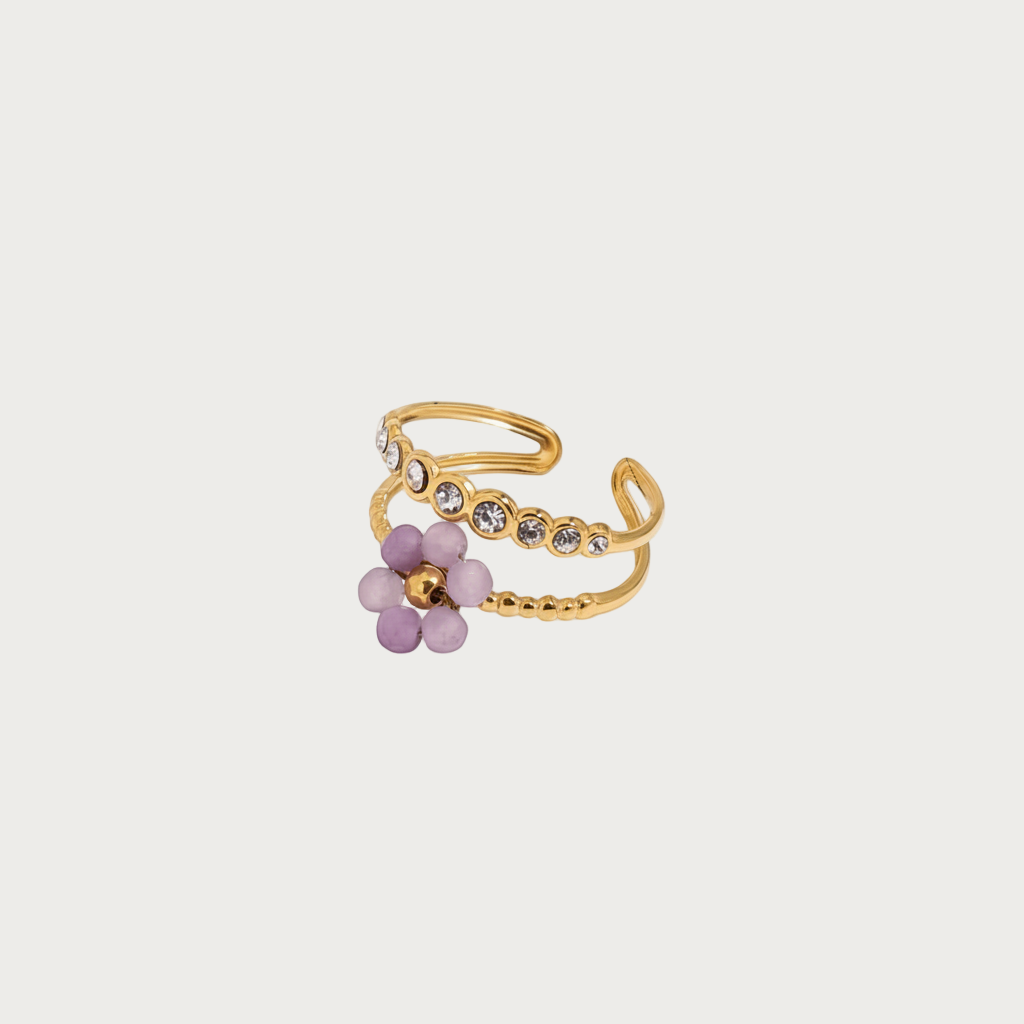 Gouden RVS ring met paarse bloem en glinsterende steentjes voor dames. Stijlvolle bloemenring.