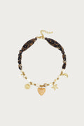 Bruine statement ketting met luipaardprint, kralen en gouden bedels in de vorm van een zon, hart en maan.