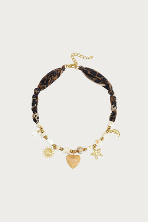Bruine statement ketting met luipaardprint, kralen en gouden bedels in de vorm van een zon, hart en maan.
