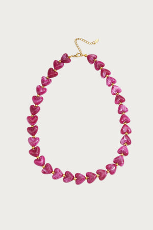 Paarse hartjes ketting van stainless steel, met glimmende paarse en roze parels en een gouden sluiting.