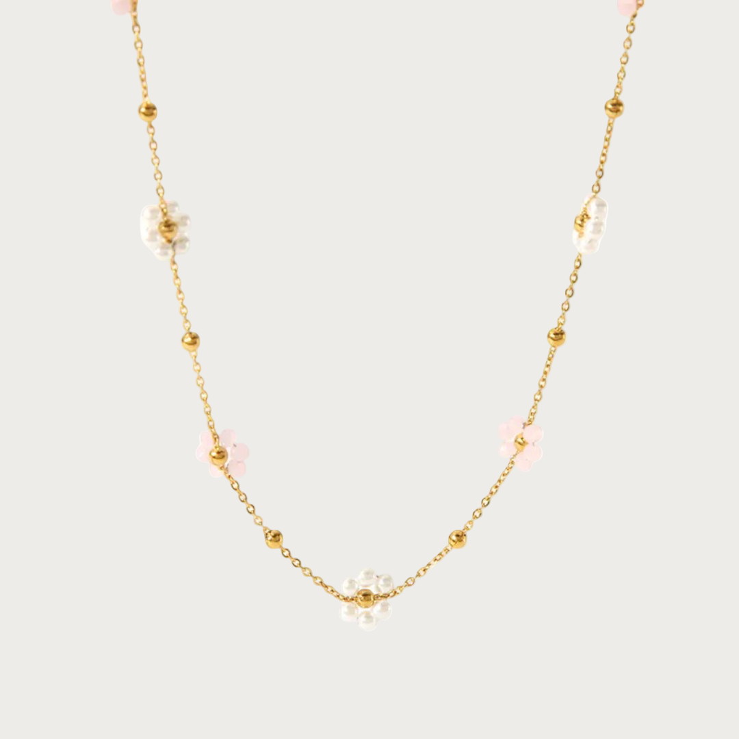 Gouden Miranda ketting van stainless steel met lichtroze en parelmoer bloemkralen en gouden bolletjes