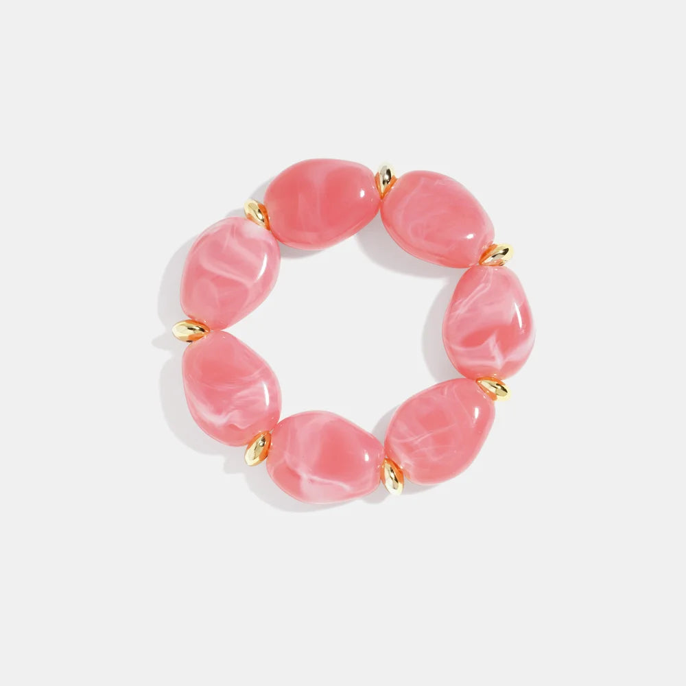 Roze Squoval kralenarmband met grote ovale kralen en gouden details, gemaakt van stainless steel, stijlvolle dames accessoire.