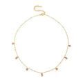 Gouden stainless steel ketting met roze ronde en rechthoekige steentjes, verstelbare sluiting.