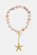 Ketting met kralen van zeeschelpen, charms en hangende zeester