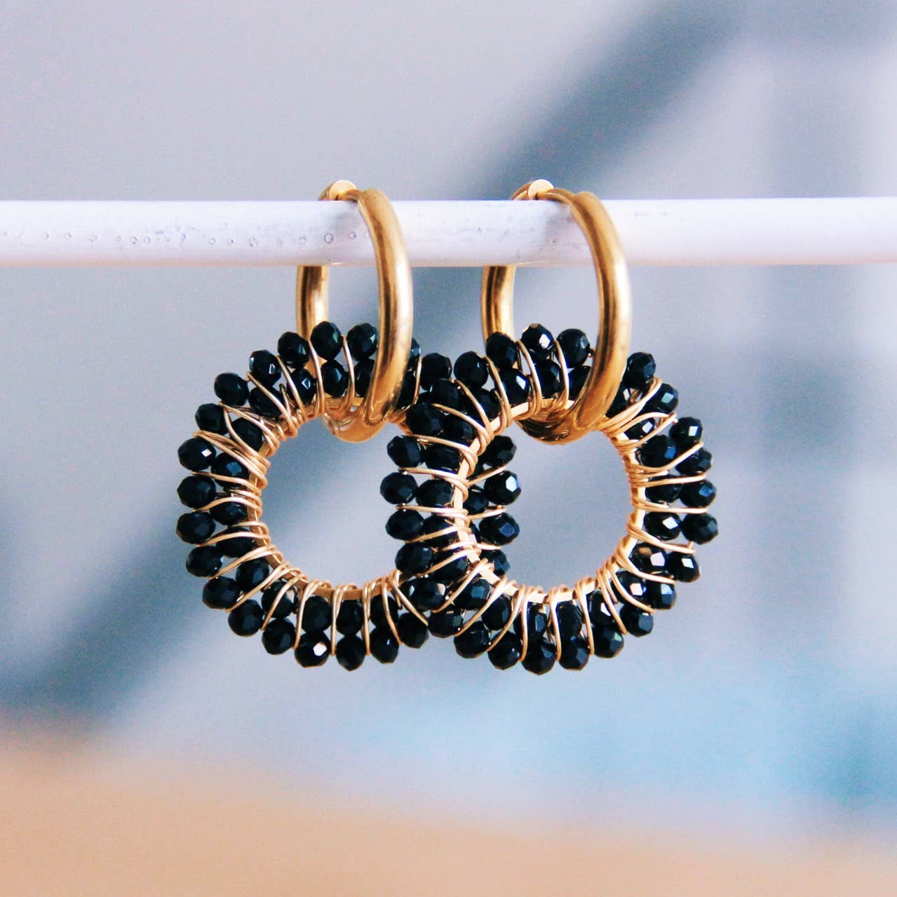 Gouden stainless steel oorringen met zwarte kralen en gouden wire wrap, elegante oorbellen