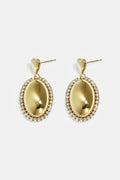 Statement oorbellen met ovale charm omringd met steentjes