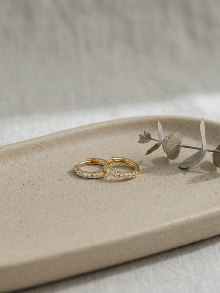 Close-up of small, sparkling 8mm hoop earrings made from shiny stainless steel, perfect for everyday elegance